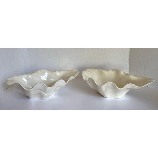 This pair of 1979 studio pottery bowls, signed “Lillie” on the underside, features beautifully sculptural sea shell/clam...