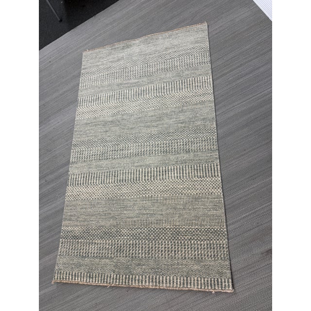 Design Plus Gallery presents a 3ft 1in × 5ft 2in Flat Weave Area Rug. the rug has a modern to contemporary look to it with...