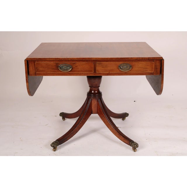 English regency mahogany sofa table, circa early 19th century. With a mahogany top with burl ash crossbanding and two D...