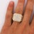 Natural 3 carat total weight round brilliant and baguette diamond cluster statement ring in 14K yellow gold, featuring a...