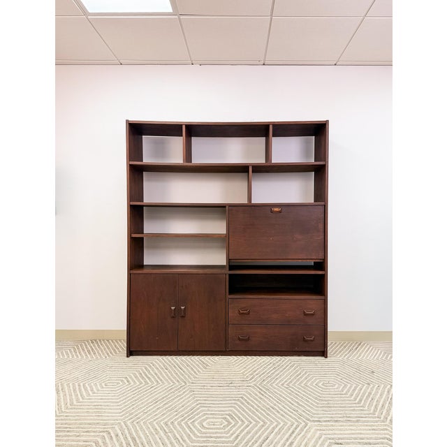 Bring timeless mid-century style and functionality into your home with this vintage walnut MCM wall unit. Featuring a...