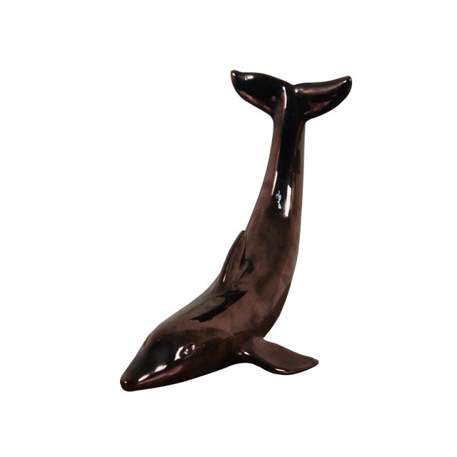 Vintage porcelain sculpture / figurine in the shape of a dolphin with tail in the air, finished in an iridescent /...