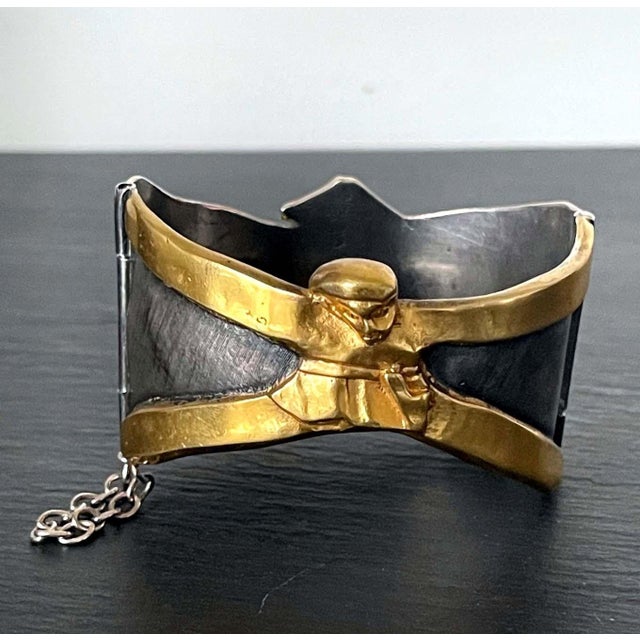A rare cuff bracelet in gilded and silvered bronze by Parisian art jewller Line Vautrin (1913-1997). The playful piece is...