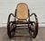 This is a beautiful vintage Thonet-style bentwood rocking chair featuring a dark stained beechwood frame, dramatic double-...