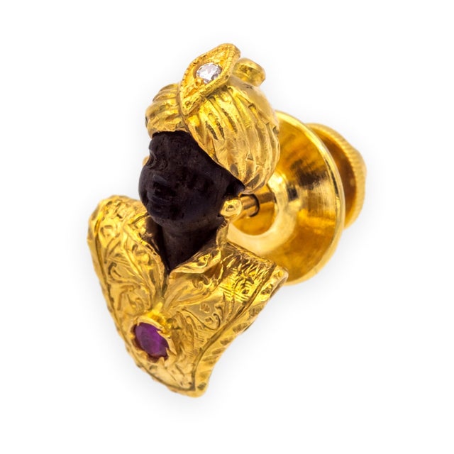 A finely detailed vintage Blackamoor bust pin in 14K and 18K yellow gold, featuring a carved dark stone head wearing an...