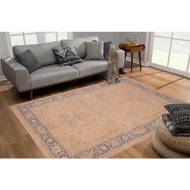 Enhance the ambiance of your home with this magnificent Persian-influenced Turkish hand-knotted rug made by skilled...