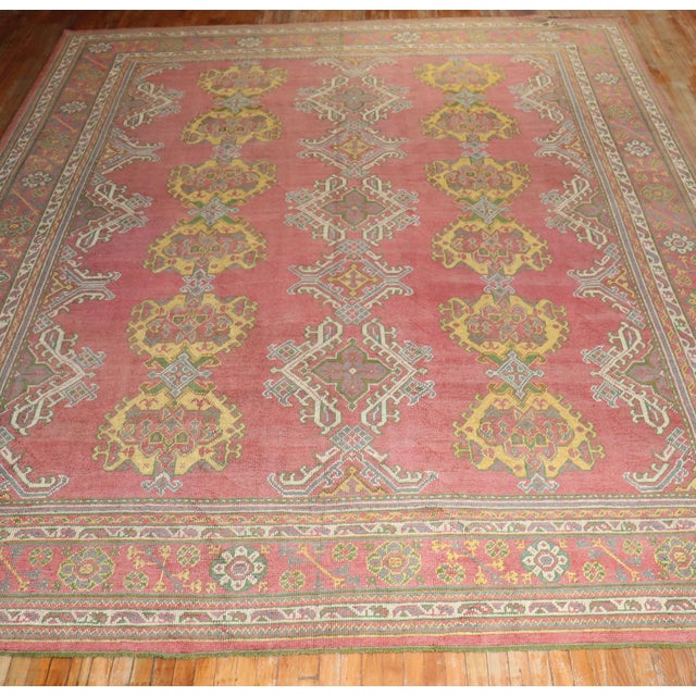 An early 20th Century Turkish Oushak Rug with an all over crab design on a pinky red ground Details rug no. j3139 size 11'...