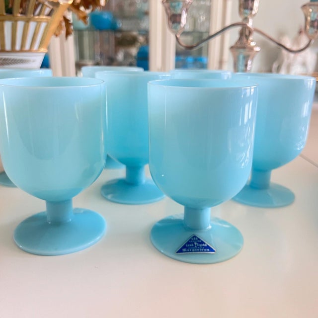 This is a beautiful set 7 of blue opaline water or wine glasses by Morgantown, one retaining the original label that...