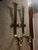 Pair of very large solid brass sconces for candles by Chapman marked 1972 in a Gothic style. Each measures 29” long and 6”...