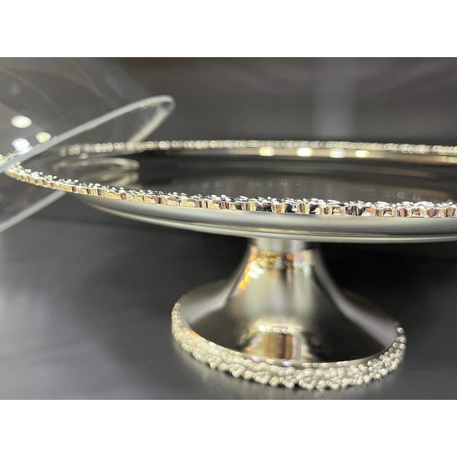 Handcrafted brass base with delicate floral details, polished with a silver-plated finish. The clear, durable acrylic...