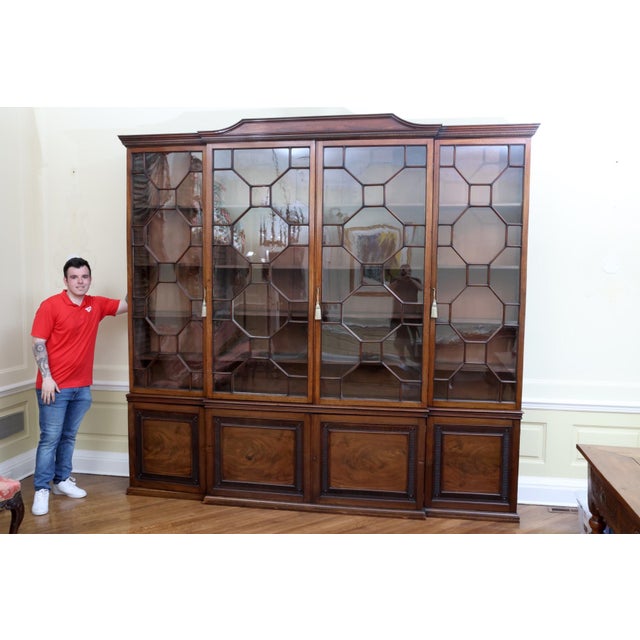 A large, impressive and fine quality George III-style mahogany breakfront bookcase—of a substantial scale with...