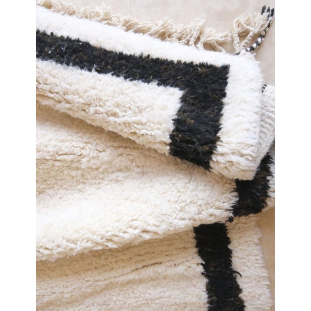 Immerse your space in authentic Moroccan artistry with this stunning wool rug. Hand-crafted using traditional Berber...