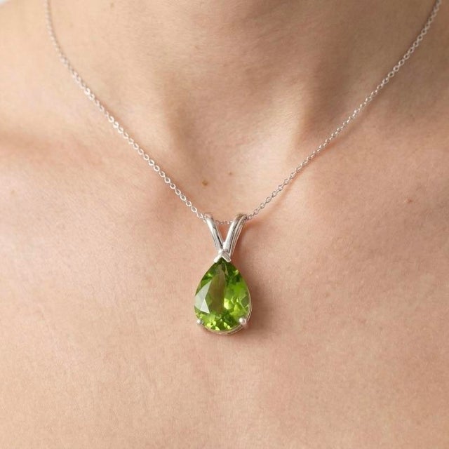This elegant pendant features a vibrant Peridot gemstone, admired for its fresh green brilliance and lively sparkle. Known...