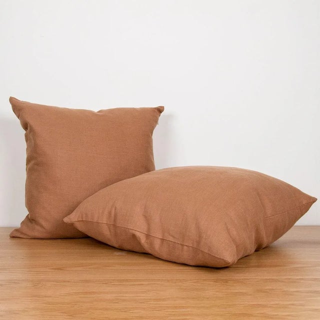 Square linen pillow with zipper closure.
