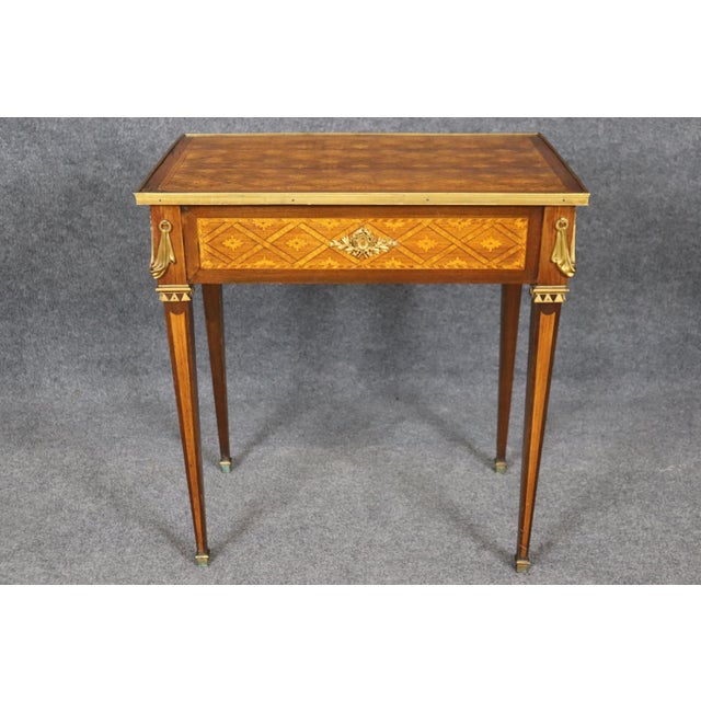 This is a superb, absolutely decadent bronze mounted end table with a single drawer and drop-dead-gorgeous marquetry inlay...