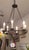 This lovely chandelier is a genuine designer original in hand wrought iron. It features 6 lights and is in new condition....