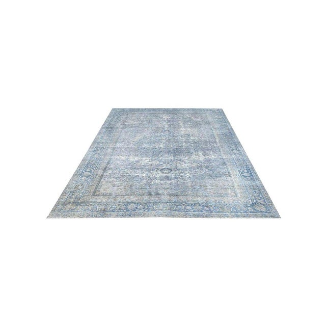 Add a touch of timeless elegance to your space with this stunning 7x10 antique Persian Kerman area rug. Originating from...