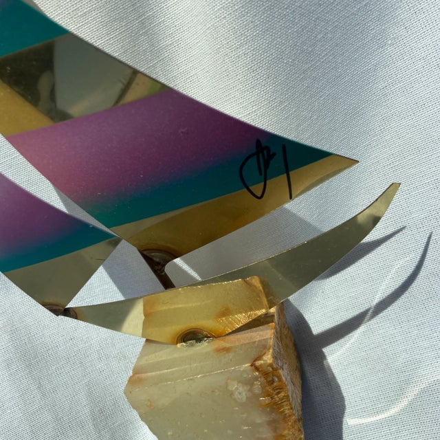 This colorful brass sailboat sits on a stone base and is signed by the artist . This item would look great on a desk or on...