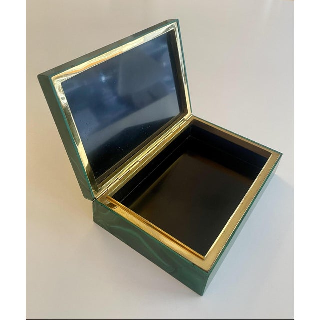 A breathtaking malachite box crafted from a particularly beautiful stone with meticulous handiwork by a jeweler, featuring...
