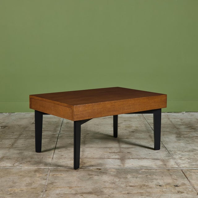 George Nelson expandable coffee table for Herman Miller, c.1950s, USA. The unique table features a stained maple table top...