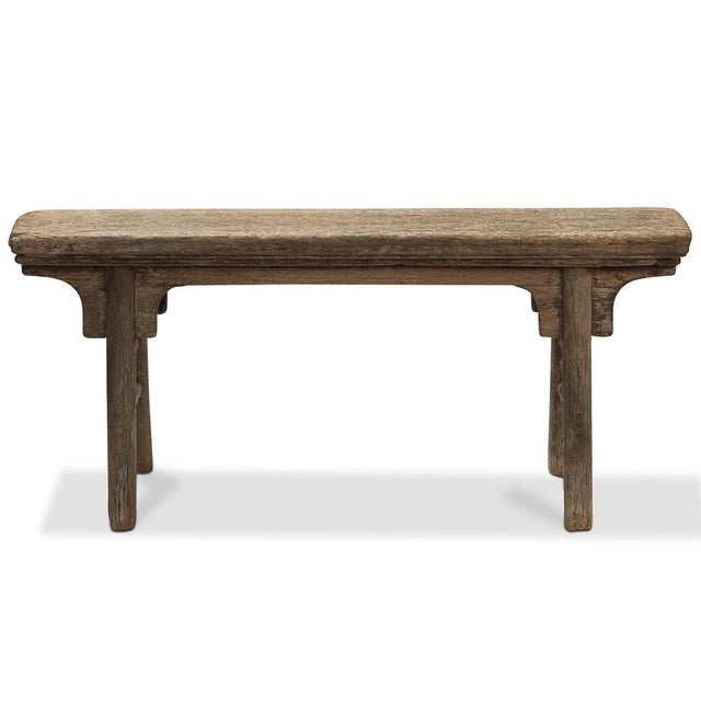 This antique Chinese bench from Shanxi, circa 1920, is a versatile and durable piece made with traditional elm wood. with...