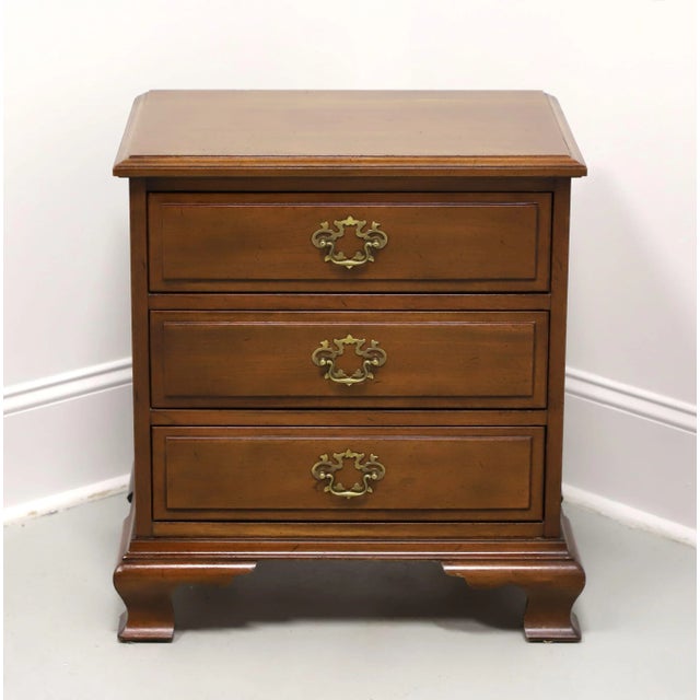 A Chippendale style bedside chest by high-quality furniture maker Hickory Chair. Mahogany with a distressed finish, brass...