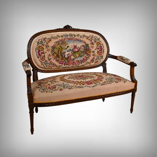 This Louis XVI style sofa, crafted from stained beechwood around 1920, embodies all the refinement and decorative rigor...