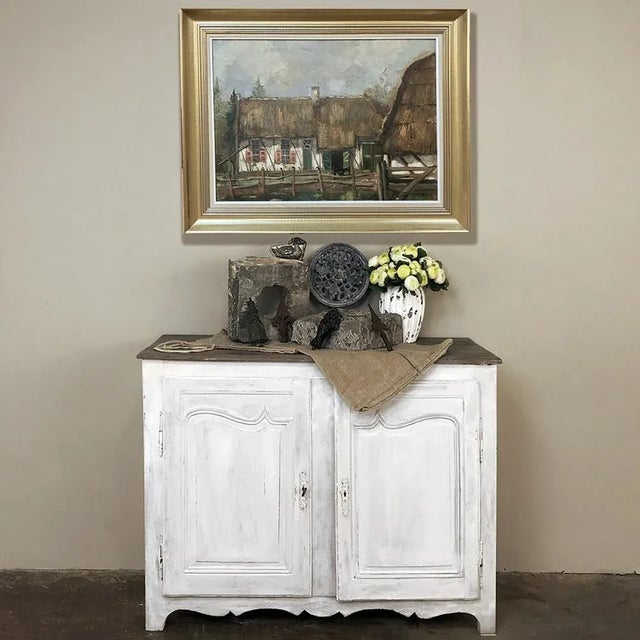 18th Century Country French Provincial Painted Buffet boasts tailored, elegant lines that combine with the distressed...