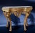 Roman mid-18th century gilt-wood Rococo consoles with a Yellow Siena veneered marble top within a black marble surround,...