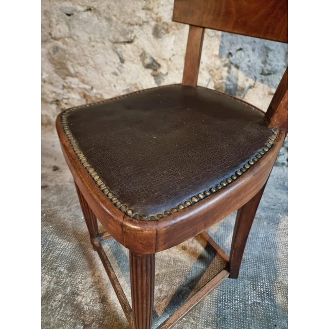 This antique French chair dates from the early 1900s and is crafted from solid beechwood. The backrest is formed from a...