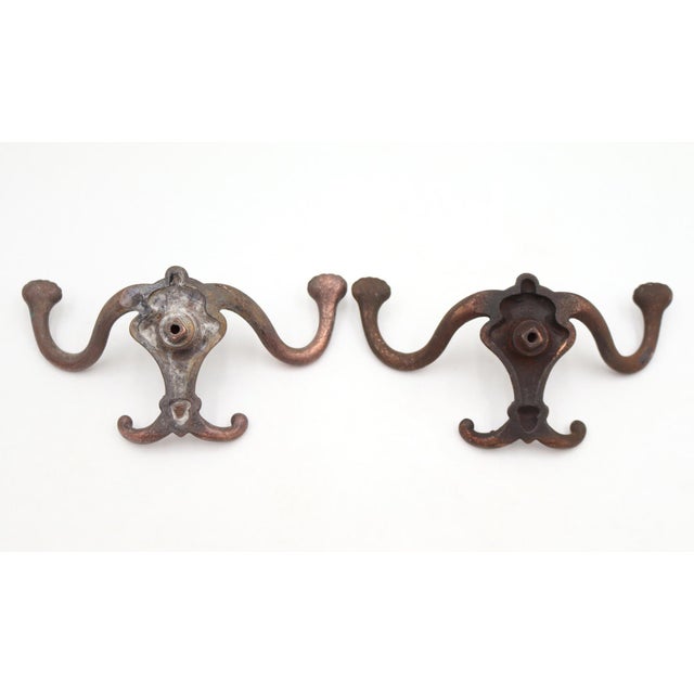 Antique Victorian style hall tree hooks made of cast iron with a mixed copper and black finish. The original mounting...
