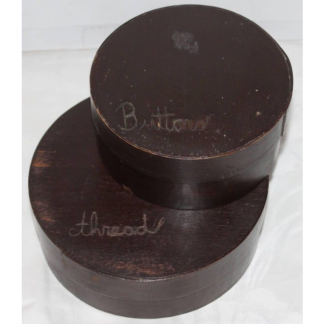 Pair of folky original painted pantry boxes. One is larger then the other. The smaller of the two is carved buttons and...