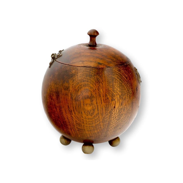 English oak tobacco jar dating to the 1920s, crafted in an unusual rounded form with rich tiger grain oak. Raised on small...