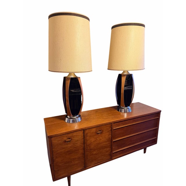 Striking pair of oversized vintage table lamps by Lawrin Lamp Company, circa 1970s. Each lamp features sculptural walnut...