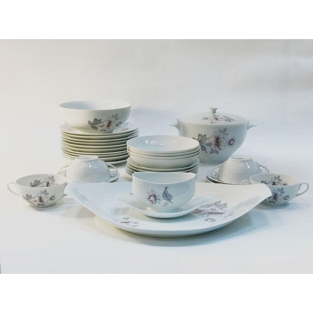 Delicate porcelain dinner set with flower pattern. 1 Soup tureen 1 Salad bowl 1 Sauce bowl X (Large serving plate not...