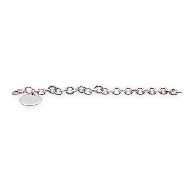 A classic Tiffany & Co. bracelet in solid sterling silver, featuring the iconic Return to Tiffany round tag. The polished...