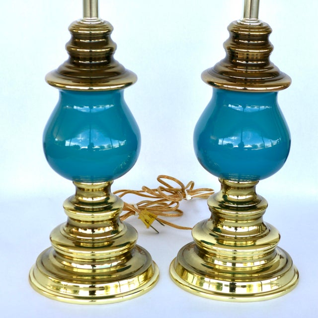 Captivate your space with this stunning, authentic pair of 1960s Hollywood Regency table lamps manufactured by the...