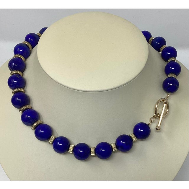 The 23 beads in this necklace are exceptionally beautiful.. They are genuine dyed lapis measuring 16mm and strung on a 19"...