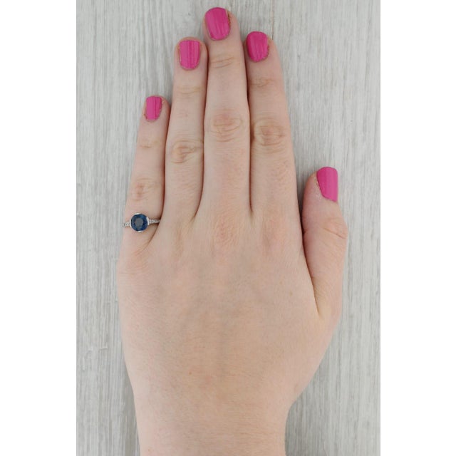 Gemstone Information: - Natural Sapphire - Carats - 1.60ct Cut - Round Brilliant Color - Dark Blue Treatment - Heated -...