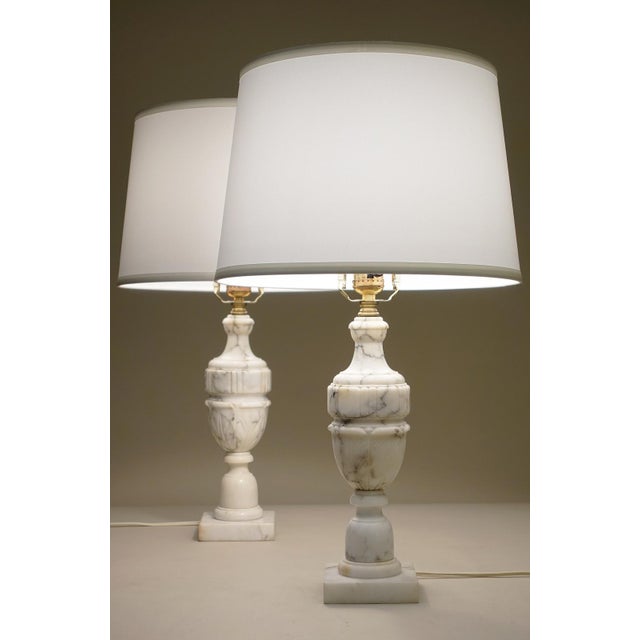 A striking matching set of Italian Carrara marble Neoclassic Art Deco Empire Regency Urn style table lamps from Italy...