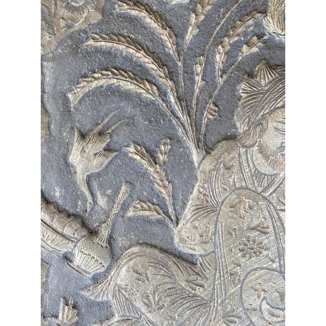 A large oversized Persian copper plate hand-crafted with intricate embossed details. At its center, a romantic garden...