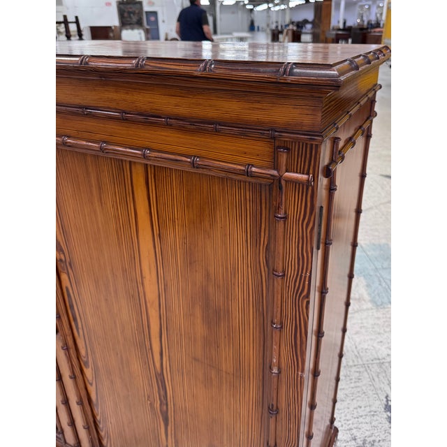 This 19th Century Faux Bamboo cabinet would allow style and storage in so many rooms! It is a boldly grained pine cupboard...