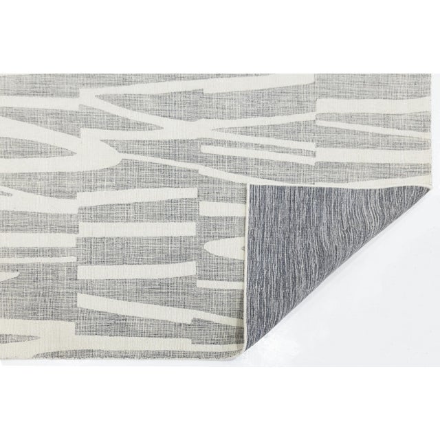Elevate your space with this Contemporary Hand-knotted Wool Rug, featuring a dynamic, abstract geometric pattern in a...