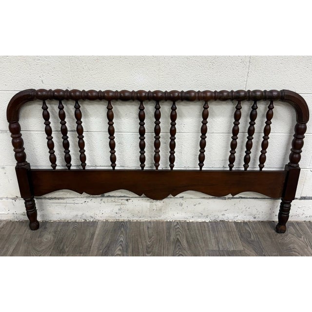 This is an antique Victorian Jenny Lind-style full-size headboard featuring a continuous bobbin-turned top rail, rows of...