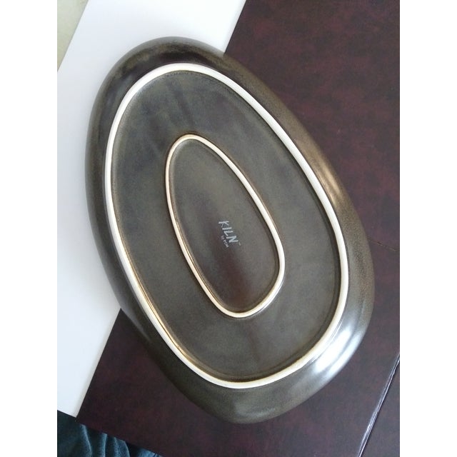An easy to clean oval shaped plate with glazed mocha brown finish. High quality construction measuring 14x9x1.5 inches....