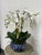 Design Plus Gallery presents an Orchid in a Fishbowl from Winward Home. The flowers and leaves are made from polyester and...