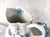 This is a Johnson Brothers Flow Blue forty ounce pitcher in the Glenwood pattern. The pitcher is white with a teal blue...