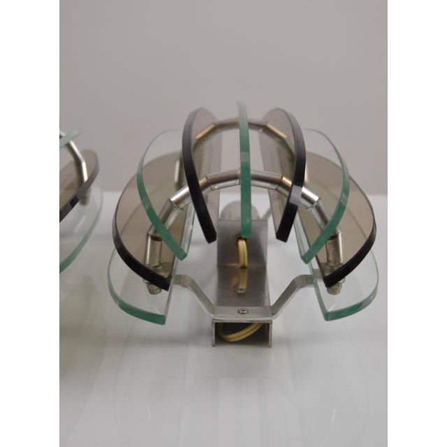 Elegant and rare pair of italian wall sconces produced by veca in the 1970s, distinguished by their striking nine-glass-...