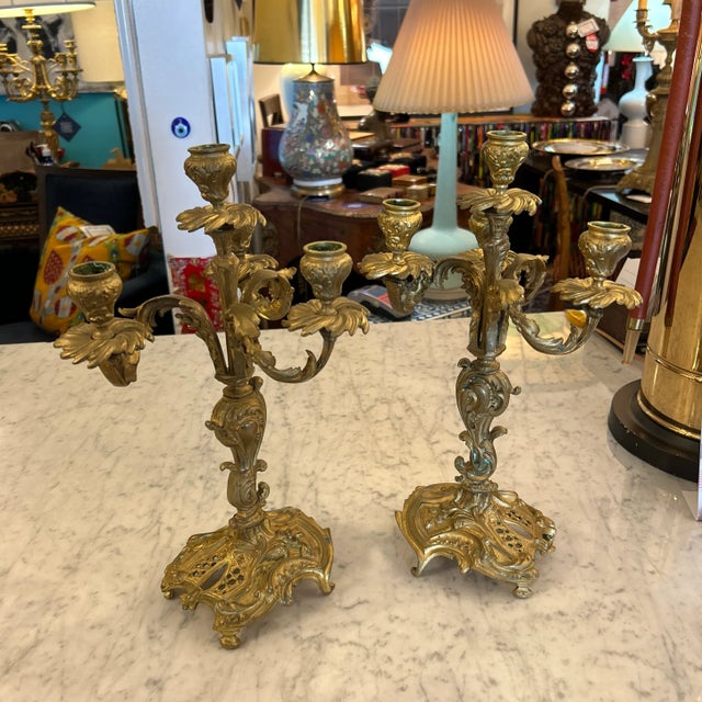 Exquisite pair of bronze tabletop candelabra. They each have 3 arms and a center post // they hold 4 candles each.