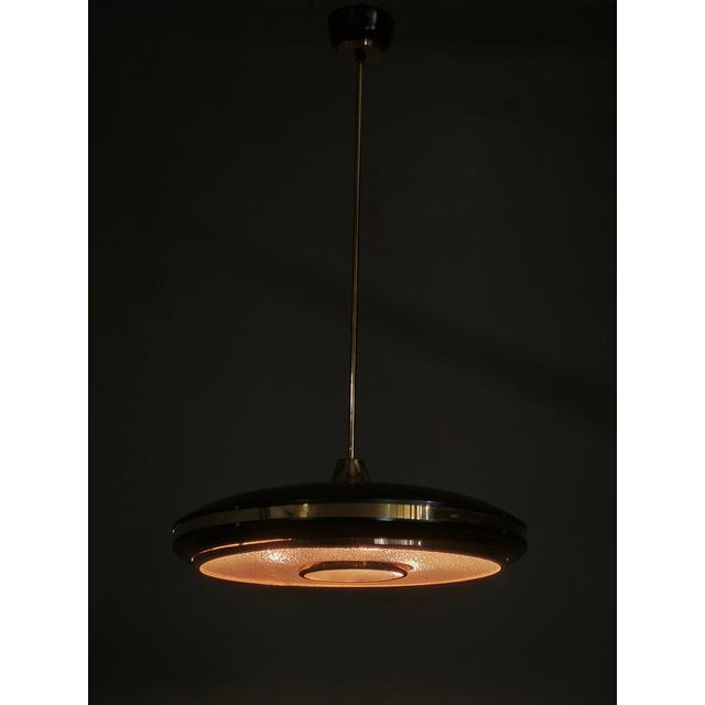A distinctive space age ufo pendant light manufactured by ludib bratislava in czechoslovakia during the 1960s, retaining...